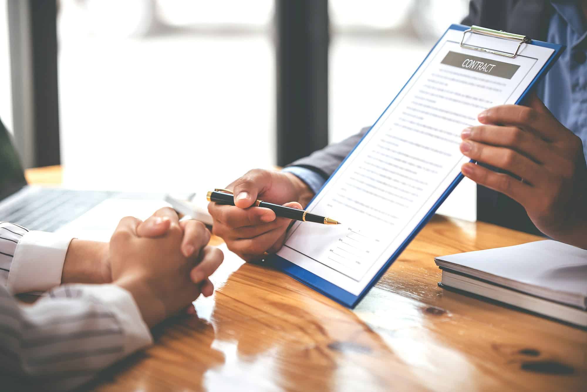 business people negotiating contracts with the documents on the table and sign the contract