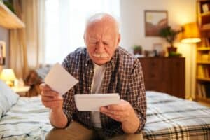 Old man remembering past events with photos