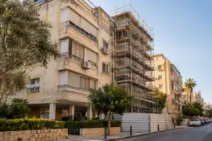 בניין מגורים ותיק עם פיגומים לחיזוק המבנה