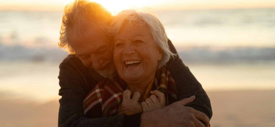 Old couple in love at the beach